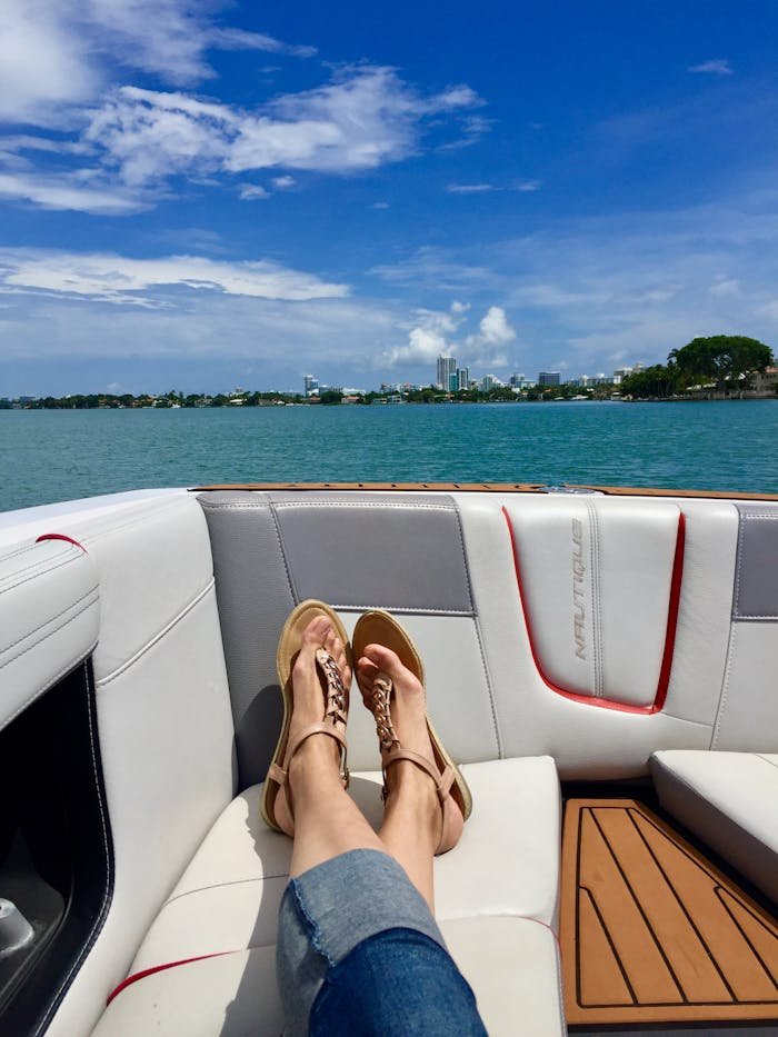 Enjoy a sunny day relaxing on a luxury yacht with a city skyline view.