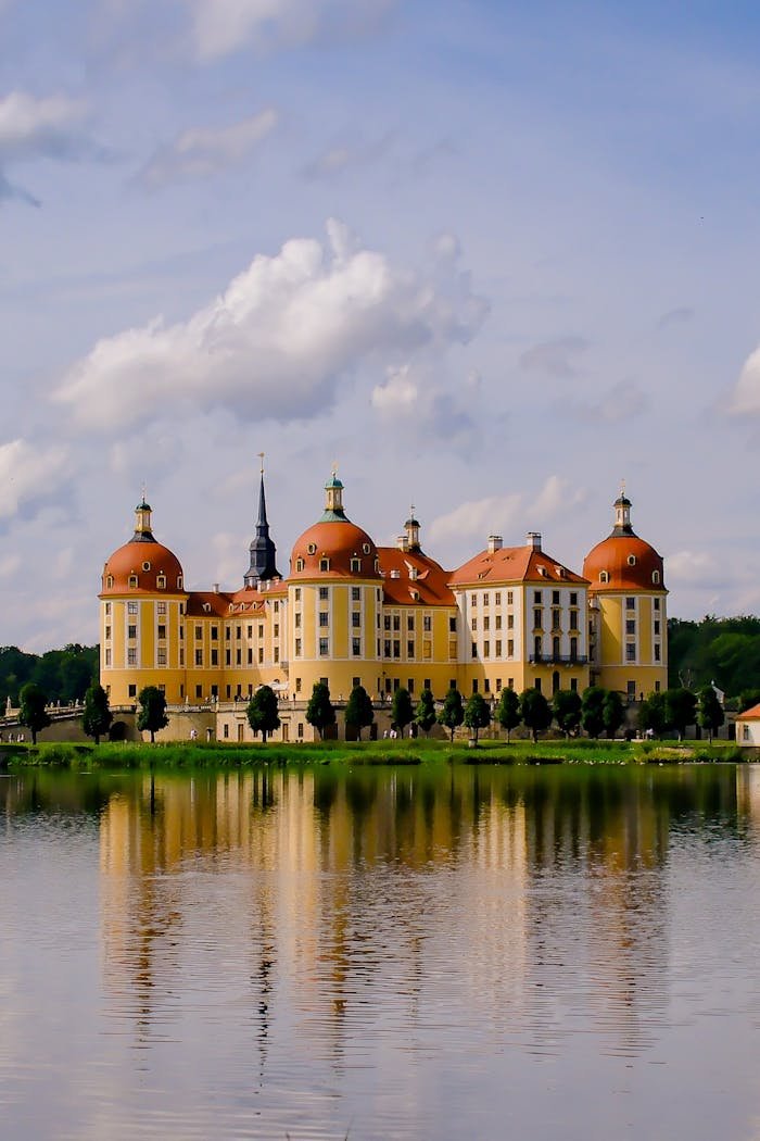 Majestic Moritzburg Castle reflecting on the lake on a sunny day in Germany.